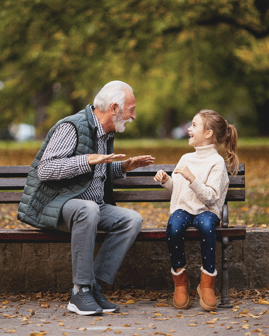 Grandfather playing red hands slapping game with his granddaught